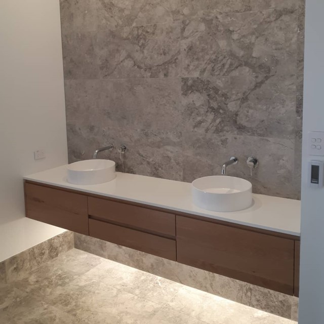 Floating timber bathroom vanity with dual sinks and under-lighting